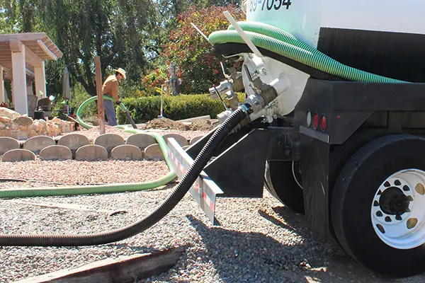 Technician providing septic tank service for a Reno, NV homeowner